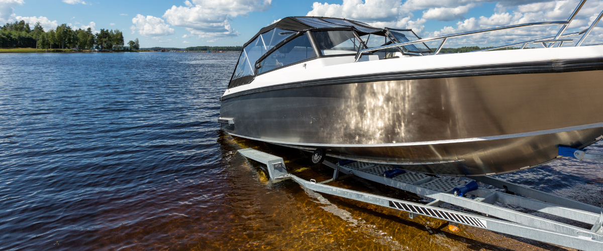 Boat being launched into the water on a lake.