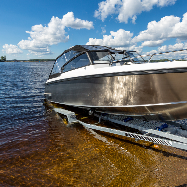 Boat being launched into the water on a lake.