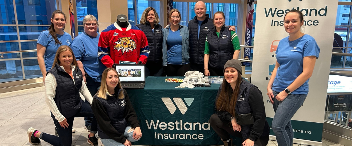 Westland Insurance employees at a booth at the Moncton Wildcats game.
