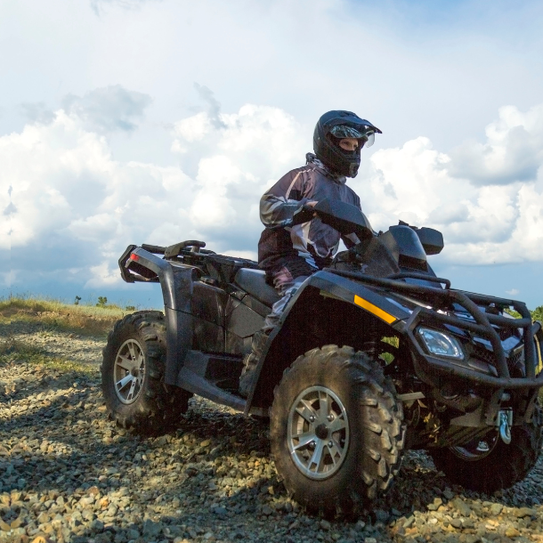 Person driving an off-road vehicle.