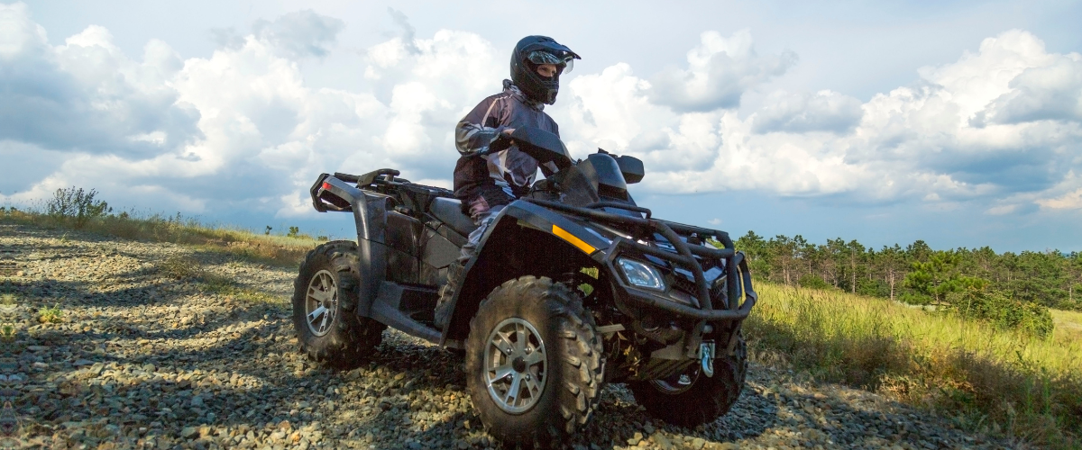 Person driving an off-road vehicle.