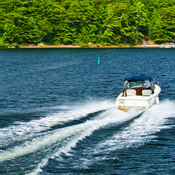 Boat driving on a lake on a summer day.