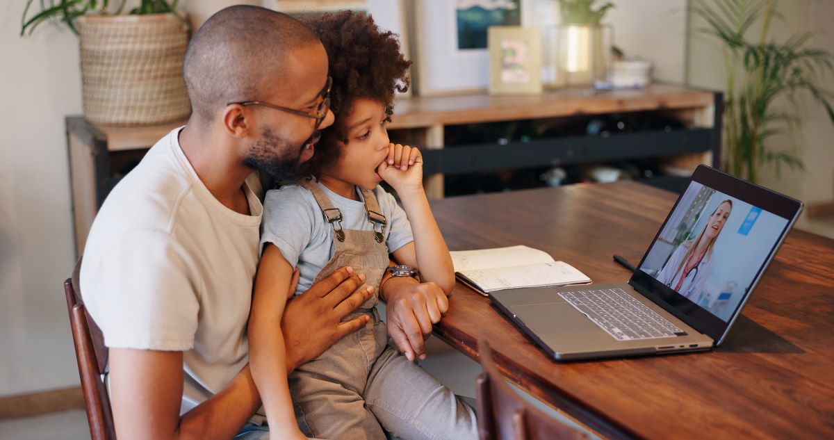 Father and child having a virtual doctors appointment